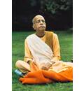 Prabhupada Sitting on Blanket on Grass Chanting Japa