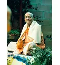 Prabhupada Smiling Sitting in Garden Chanting Japa