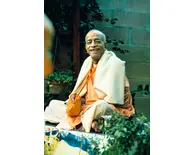 Prabhupada Smiling Sitting in Garden Chanting Japa