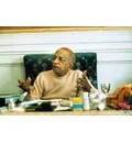 Prabhupada Sitting at Desk Explaining Philosophy to Guests