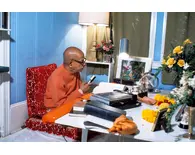 Srila Prabhupada Sitting at his Desk Translating Srimad-Bhagavatam