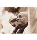 Srila Prabhupada dancing on a stage with arms raised in the air